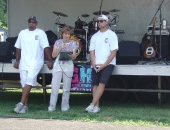 Senator Schwank presents a Senate citation congratulating Pittsburgh Steeler tight end John Gilmore, left, and Miami Dolphin quarterback Chad Henne, right, for the establishment by the two Berks athletes of the Gilmore/Henne Community Fund to improve local playgrounds with community-backed efforts during a project at Temple Playground on July 10.