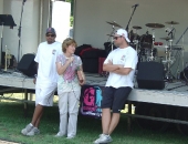 Senator Schwank presents a Senate citation congratulating Pittsburgh Steeler tight end John Gilmore, left, and Miami Dolphin quarterback Chad Henne, right, for the establishment by the two Berks athletes of the Gilmore/Henne Community Fund to improve local playgrounds with community-backed efforts during a project at Temple Playground on July 10.