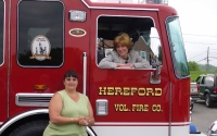 Senator Schwank presents Hereford Volunteer Fire Company with a state flag commemorating the housing.